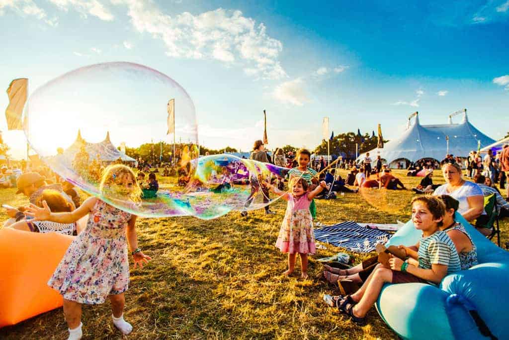 Kids playing with giant bubbles at Bluedot 2017